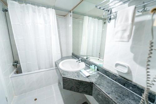 a bathroom with a sink and a mirror at Sun And Sands Downtown in Dubai