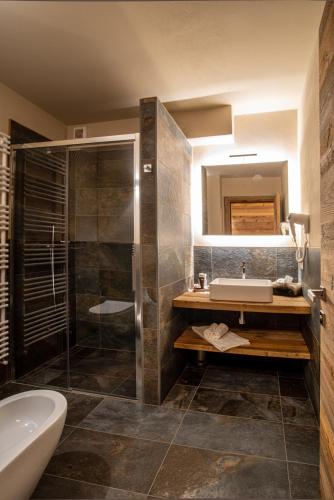 a bathroom with a tub and a sink and a shower at Al Baitin - Charme & Nature - in Santa Caterina Valfurva