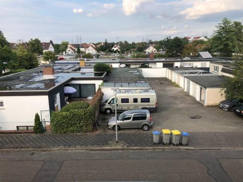 a parking lot with a van parked in front of buildings at Cheerful Roof Flat in a Private German Style House in Mannheim