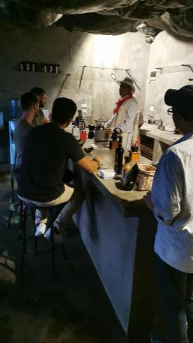 a group of people sitting at a counter in a kitchen at Cabaña Parque Arvi vista panorámica in Medellín