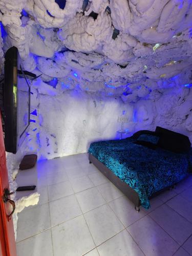a bedroom with a bed in a rock wall at Cabaña Parque Arvi vista panorámica in Medellín
