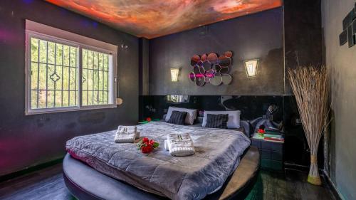 a bedroom with a bed with a painting on the ceiling at Villa de los Sueños Atarfe by Ruralidays in Atarfe