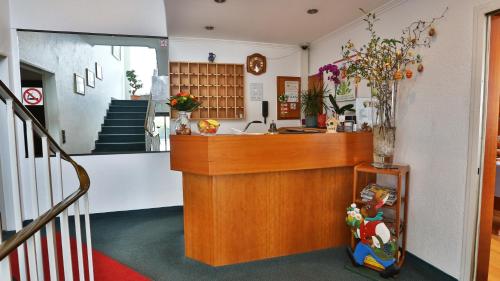 a lobby with a counter and a stair case at Concordia - Wohnen auf Zeit in Frankfurt