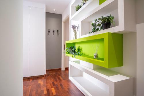 a green shelf in a hallway with plants at Appartamento nel cuore della città in Livorno