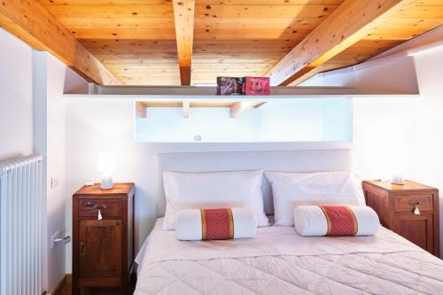 a bedroom with a bed with a wooden ceiling at Loft del porto in Fano
