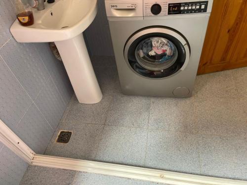 a washing machine in a bathroom next to a sink at Bienvenue chez vous in Tetouan