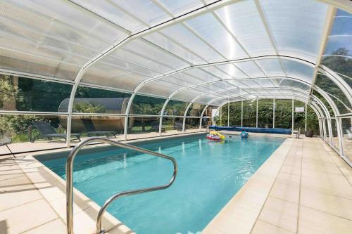 a swimming pool with a canopy over it at Rivendell Park in Wimborne Minster