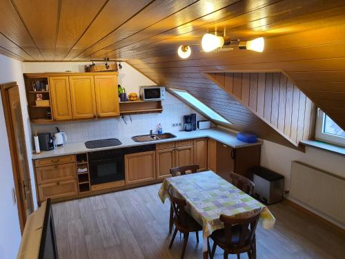 an overhead view of a kitchen with a table and chairs at Kleberhof - Urlaub auf dem Bauernhof in Eslarn