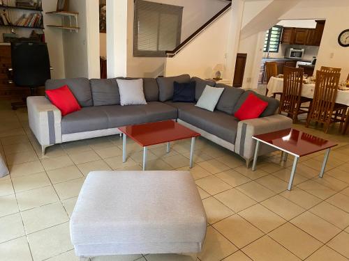 a living room with a couch and two tables at La Kaz Paille en Queue, Magnifique Villa F5 récemment rénovée avec piscine et Jacuzzi sur La Possession in La Possession