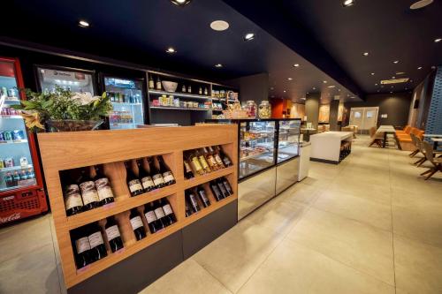 a wine store with a display of wine bottles at Ibis Budget Farroupilha in Farroupilha