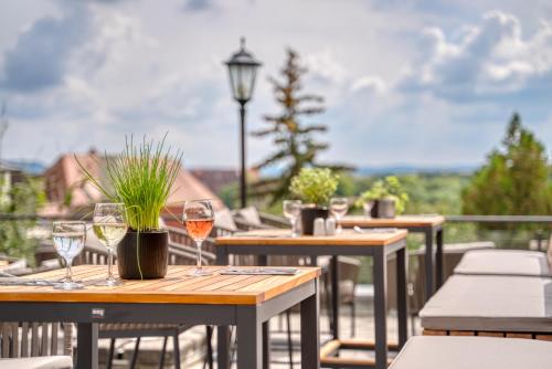 a table with glasses of wine on a balcony at Hotel Eisenhut in Rothenburg ob der Tauber