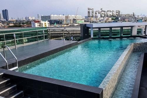 a swimming pool on the roof of a building at Bella B Hotel in Nonthaburi