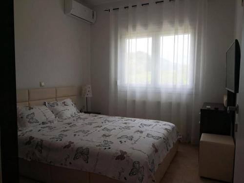 a bedroom with a bed and a window at Bella Vera Apartments 2 in Limenas