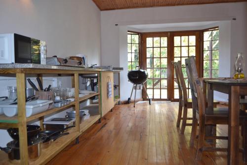 a kitchen with wooden floors and a table with a counter at The Farmers Lodge in Thorndale