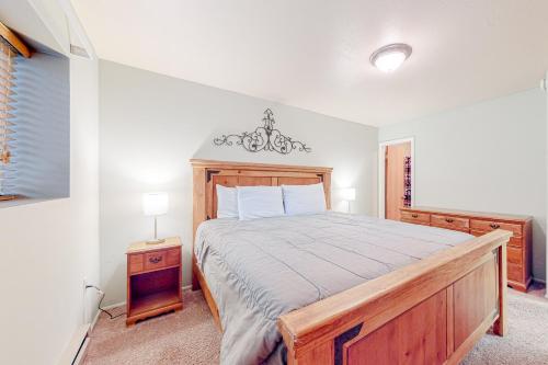 a bedroom with a large bed with a wooden headboard at Chalet Village #24 in Brian Head