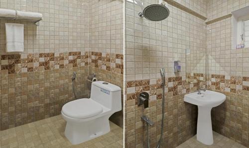 a bathroom with a toilet and a sink at Treebo Celebrity Hotels And Suites in Bengaluru