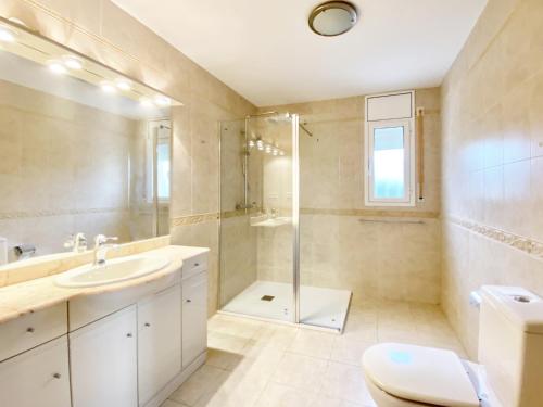 a bathroom with a shower and a sink and a toilet at Villa Libelula in L'Ametlla de Mar