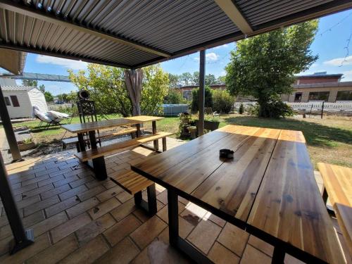 a group of picnic tables on a patio at Hani's Home Gruppenunterkunft in Verl