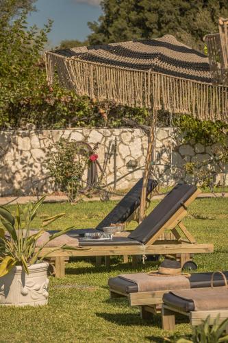 a group of chaise lounges on the grass in a yard at Queen Bee Residence in Minia