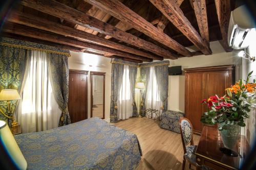 a bedroom with a bed and a table with flowers at B&B Le Marie in Venice