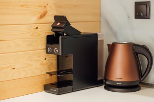 a coffee maker and a tea kettle on a counter at Telegdy Homes in Praid