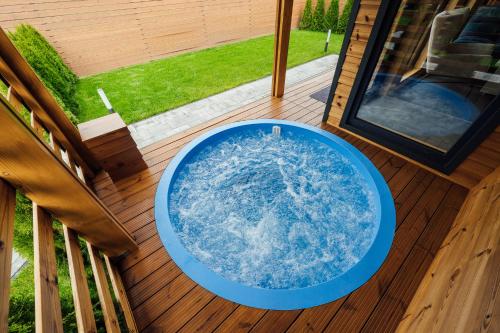 a large blue bowl on a deck on a porch at Telegdy Homes in Praid