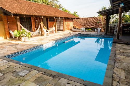 a swimming pool in front of a house at Gajah in Joinville