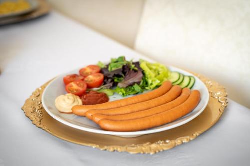 a plate of food with carrots and vegetables on a table at Hotel MAXPLAZA in Trnava