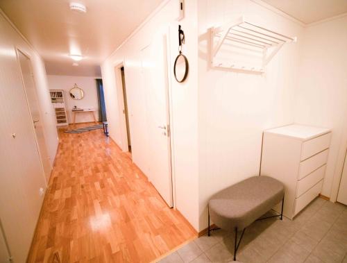 a hallway with a chair and a wooden floor at Destination Senja - Skaland in Skaland