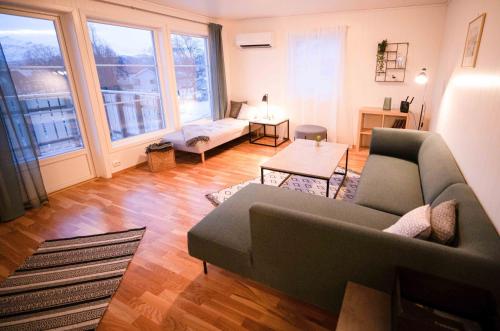 a living room with a couch and a table at Destination Senja - Skaland in Skaland
