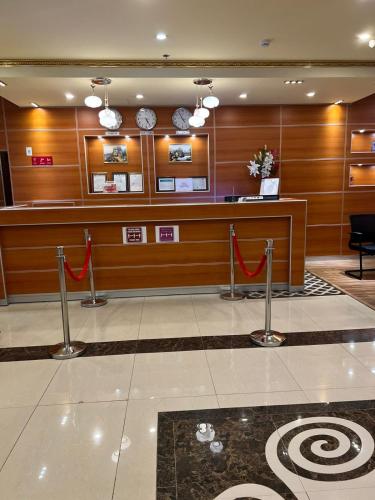 a lobby with a waiting area with red flags at Villa Park in Al Khobar