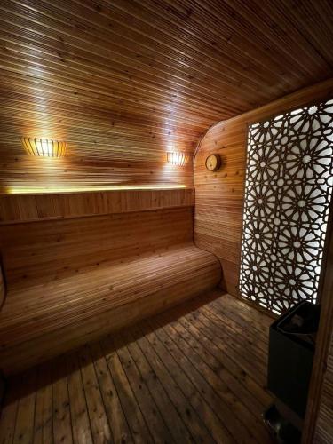 an empty wooden sauna with a window at Villa Park in Al Khobar