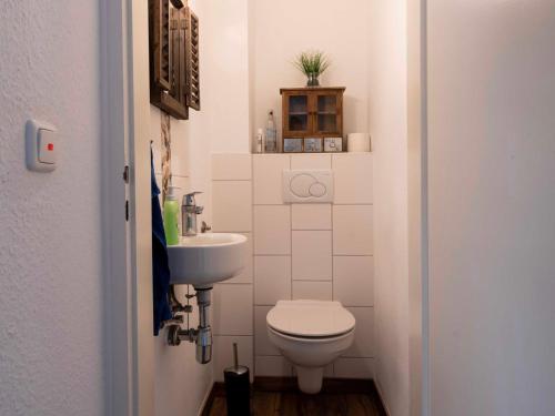 a small bathroom with a toilet and a sink at 190 Feriendomizil Nordlicht in Wilhelmshaven