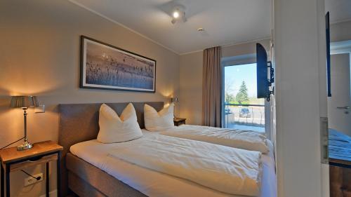 Postel nebo postele na pokoji v ubytování Elbstrand Resort Krautsand