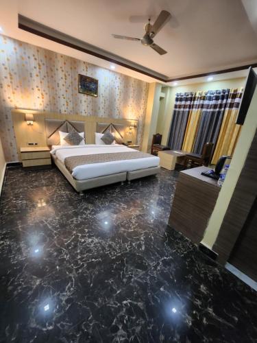 a bedroom with a bed with a marble floor at THE BODHI PALACE RESORT in Bodh Gaya