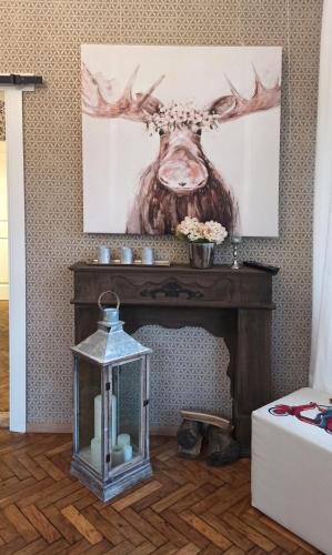 a fireplace with a deer head on top of it at FeWo im Sahneröschen in Magdeburg