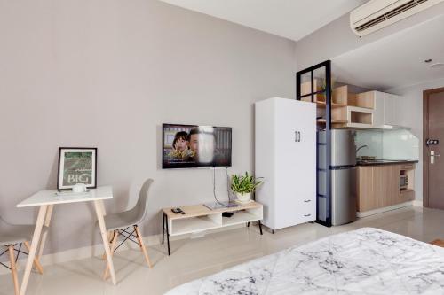 a white room with a desk and a refrigerator at Saigon Authentic Apartments - Amazing Infinity Pool and FREE Daily Breakfast Voucher, Walking Tour and 4G SIM card for 3 nights booking in Ho Chi Minh City