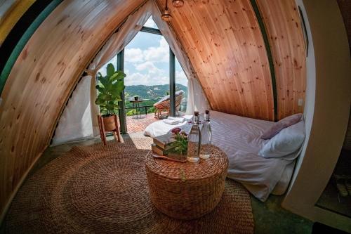 a small room with a bed and a window at Lengkeng Da Lat Homestay in Da Lat