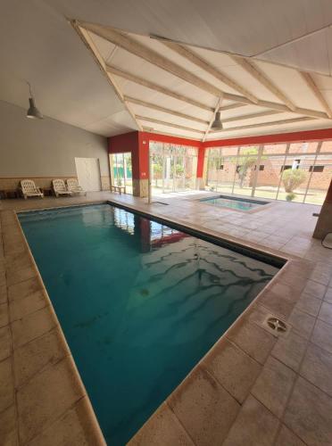 a large swimming pool in a large building at Hotel Pórtico Norte in Tartagal