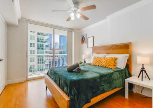 a bedroom with a bed and a large window at 2BD Condo At Brickell With Bay View in Miami