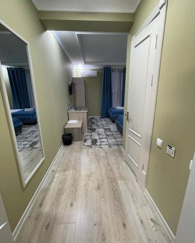 a room with a hallway with a mirror and a sink at CITIZEN HOTEL in Nukus