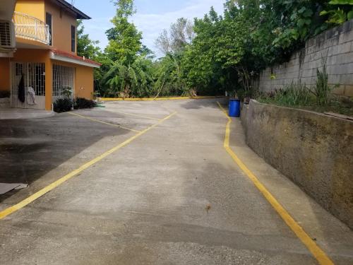 an empty parking lot in front of a building at Chaudhry Holiday House Montego Bay in Montego Bay