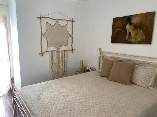 a bedroom with a bed and a mirror on the wall at ESPAÇO ALVIM in Esmoriz