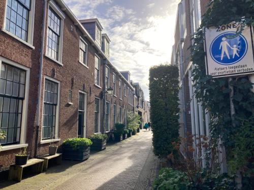 an alley with a sign on the side of a building at GuesthouseOne in Haarlem