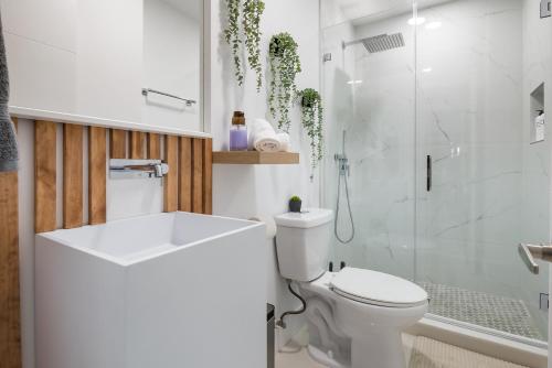 a white bathroom with a toilet and a shower at 5BR Oasis Heated Pool, Games L06 in Miami