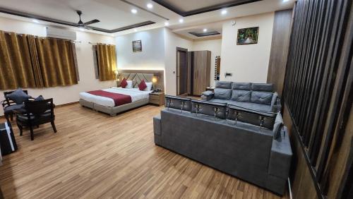 a hotel room with a bed and a couch at THE BODHI PALACE RESORT in Bodh Gaya