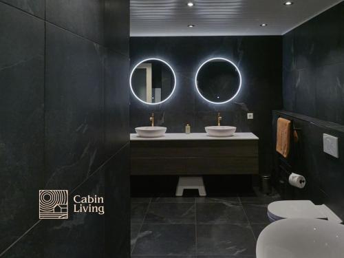 a bathroom with two sinks and a mirror at Grand cabin at Nesfjellet with lovely view, inddor Jacuzzi & sauna in Nes i Ådal