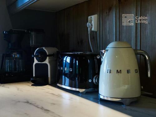 a toaster sitting on top of a kitchen counter at Grand cabin at Nesfjellet with lovely view, inddor Jacuzzi & sauna in Nes i Ådal