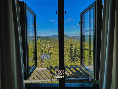 a view from a window of a house with trees at Grand cabin at Nesfjellet with lovely view, inddor Jacuzzi & sauna in Nes i Ådal