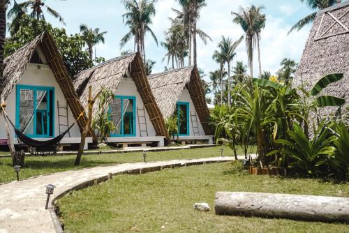 a house with a hammock in front of it at Mao Mao surf in General Luna